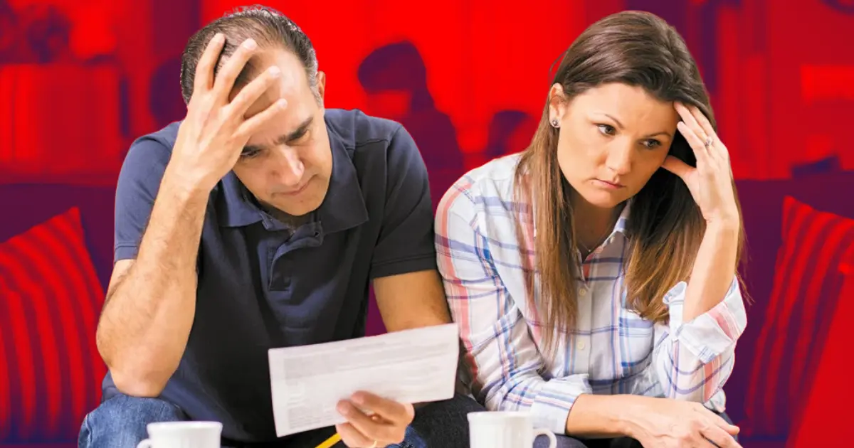 Casal da classe média preocupado com contas e dívidas em cima da mesa