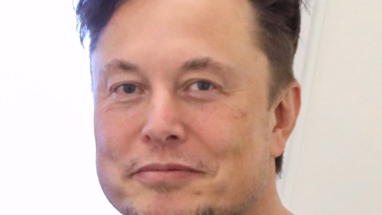 Elon Musk, dono da Tesla e da SpaceX, sorri de camiseta preta com o logo da Tesla